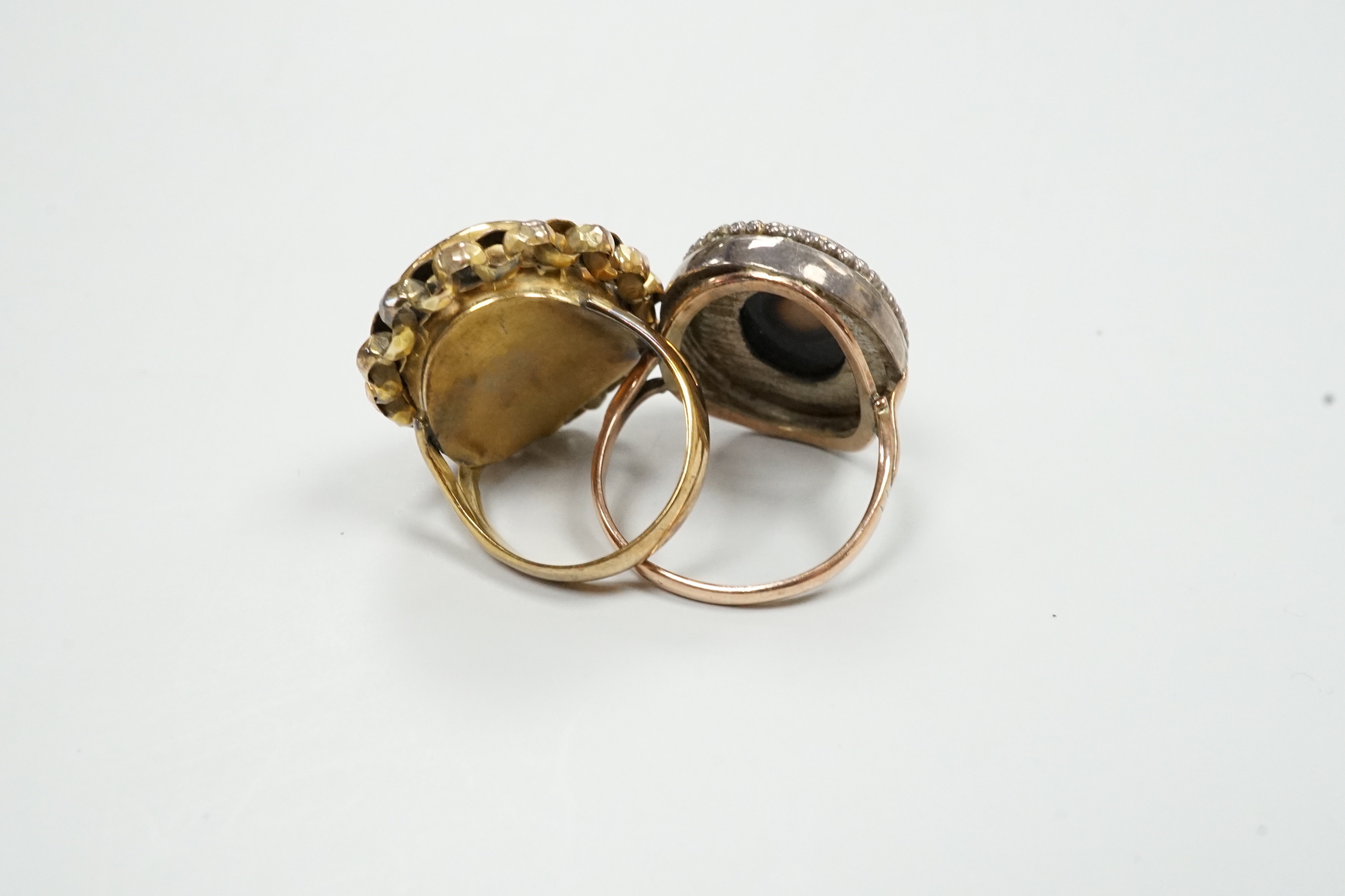 Two yellow metal dress rings, one set with cameo portrait of a lady, the other with porcelain plaque.